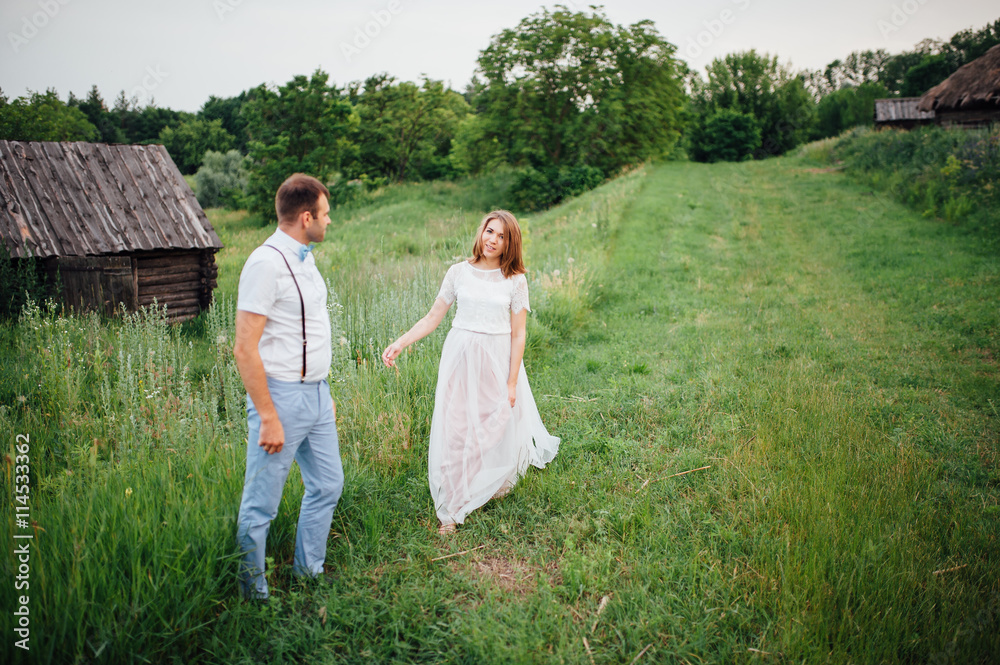 Happy Bride and groom walking on the green grass Happy Bride and groom walking on the green grass