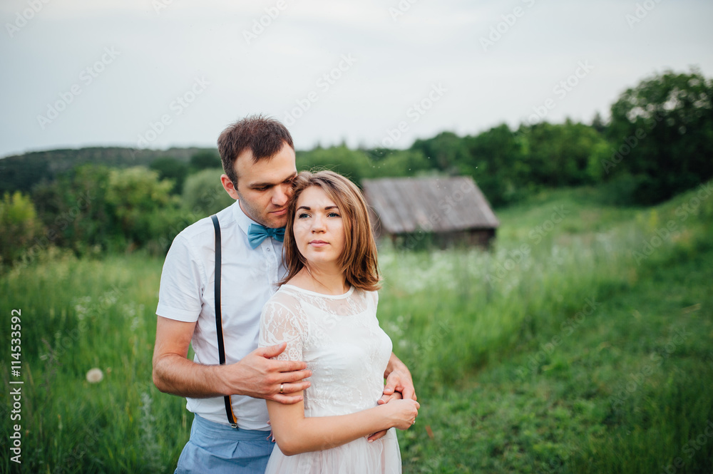 Happy Bride and groom walking on the green grass Happy Bride and groom walking on the green grass