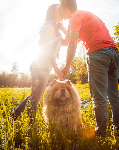 Canvas Print Young couple with the dogs in the park.