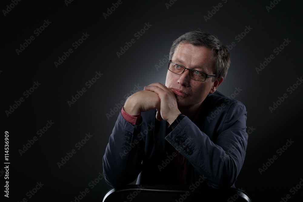 casual businessman on a dark background in studio