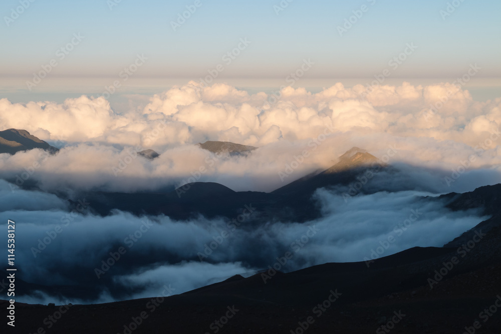 Warm and cold colors in the sunset over Haleakala with the cloud deck below the view point
