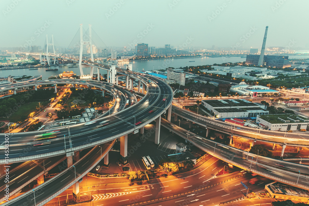 View of the Nanpu Bridge in Shanghai, China with traffic. Scenic urban skyline.