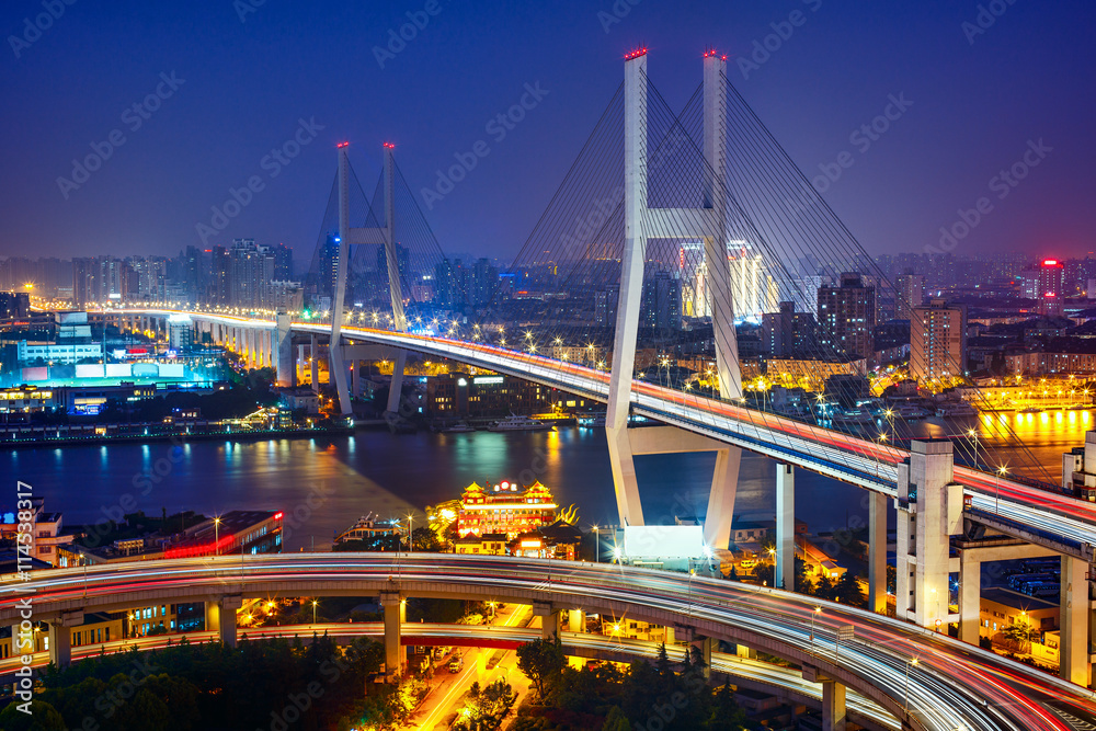 Fantastic view over the Nanpu bridge in Shanghai, China. Scenic nighttime skyline.