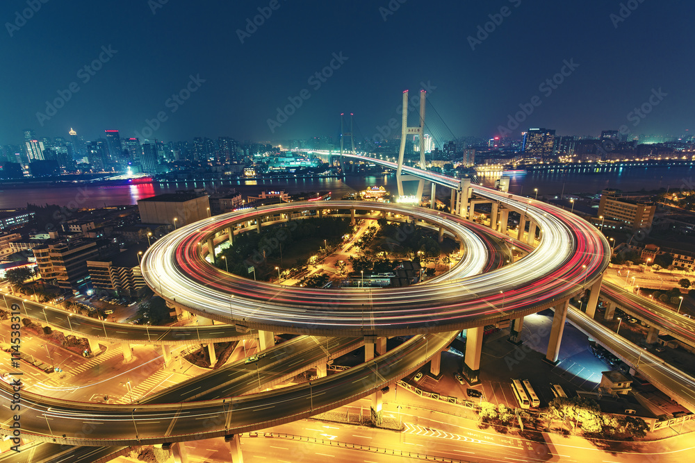 Fototapeta premium View over the Nanpu Bridge in Shanghai, China with car trails. Fantastic nighttime urban skyline.