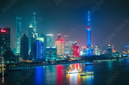 Aerial panoramic view over a big modern city by night. Shanghai, China. Nighttime skyline with illuminated skyscrapers. © Funny Studio