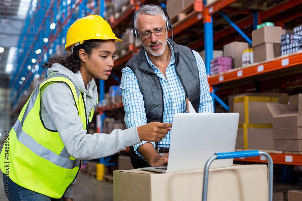 Worker and manager are looking a laptop Worker and manager are looking a laptop