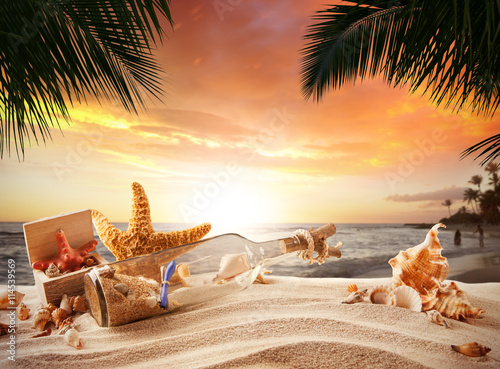 Fototapeta Naklejka Na Ścianę i Meble -  Sandy tropical beach with bottle and starfish