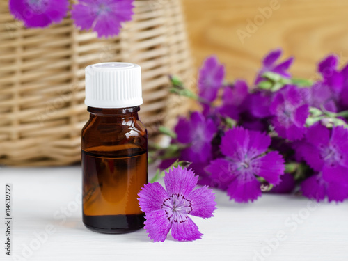 Fototapeta Naklejka Na Ścianę i Meble -  Small bottle of natural cosmetic (essential) aroma oil 
