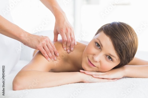 Portrait of beautiful woman receiving back massage