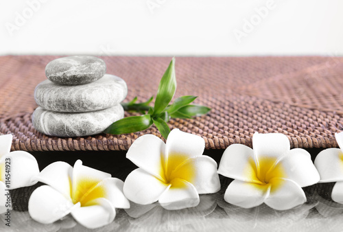 Gray spa stones with plumeria flowers  close up