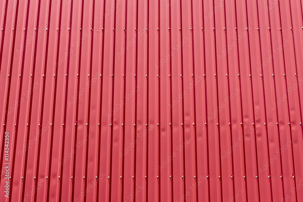 the factory building,the factory building made by sheet metal with the blue .Close-up of the red wall of factory building which made from sheet metal. the factory building,the factory building made by sheet metal with the blue .Close-up of the red wall of factory building which made from sheet metal.