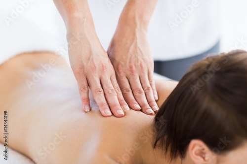 Naked woman enjoying back massage