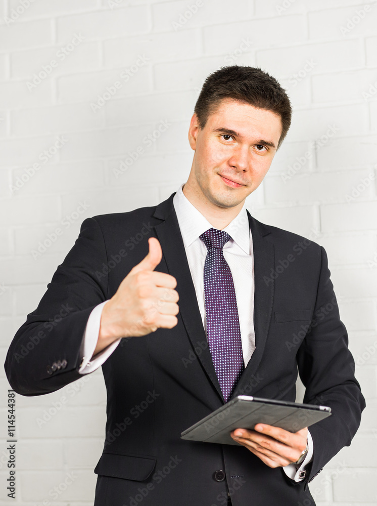 Businessman showing OK sign with his thumb up. Businessman showing OK sign with his thumb up.