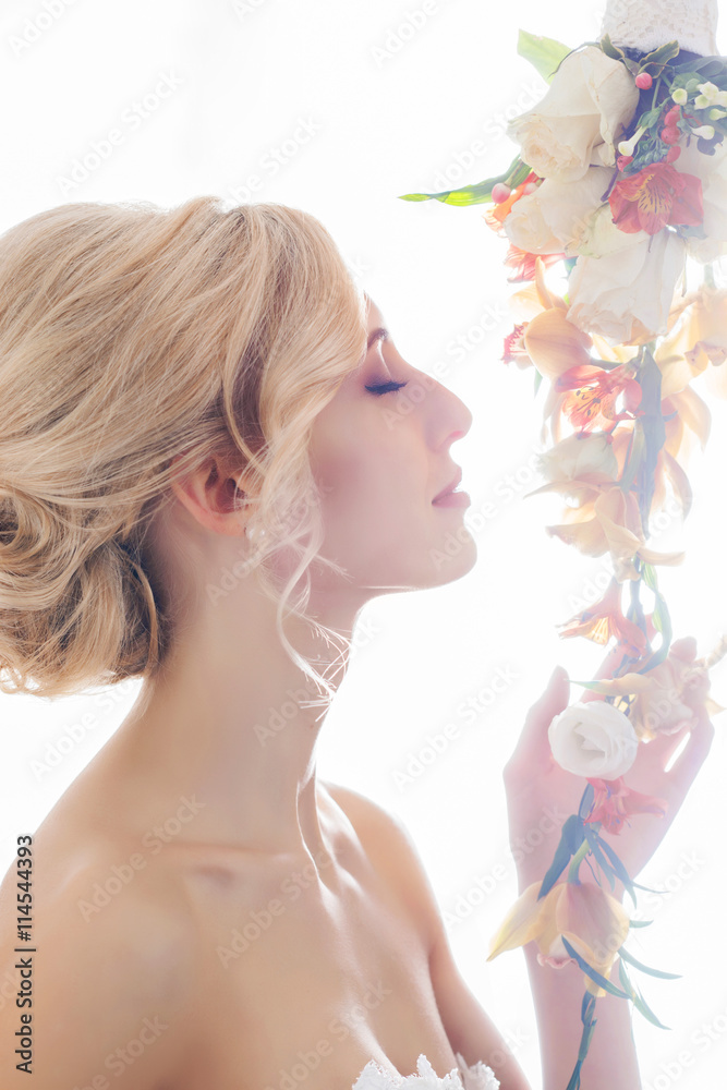 Fototapeta premium Beautiful, sensual bride in a white dress flowers