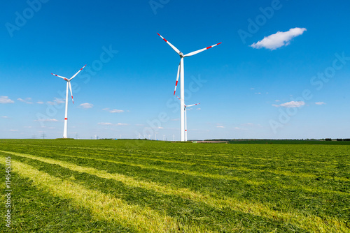Windwheels in a mowed field of hay, seen in rural Germany