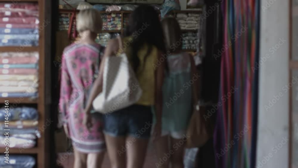 Tourist women shopping for hammock in marketplace Tourist women shopping for hammock in marketplace