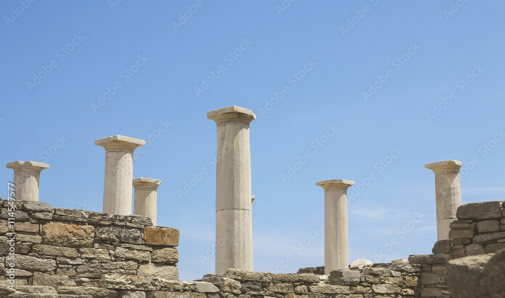 Landscape with ancient Roman time columns at Delos in Greece.
