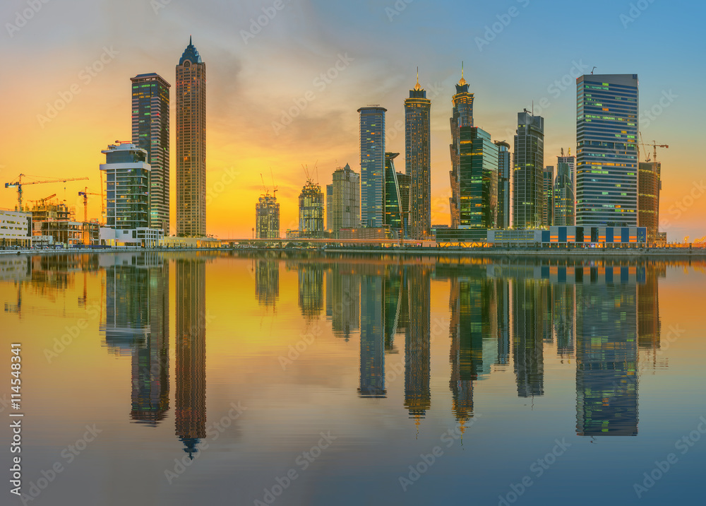 Fototapeta premium Panoramic view of Business bay and downtown area of Dubai, reflection in a river, UAE