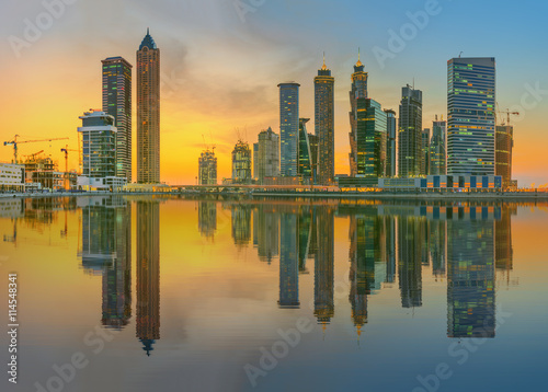 Panoramic view of Business bay and downtown area of Dubai  reflection in a river  UAE