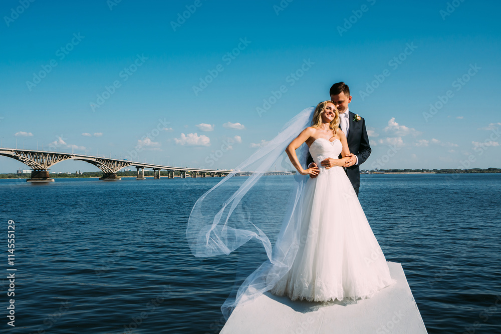 the bride and groom take pictures near the river the bride and groom take pictures near the river