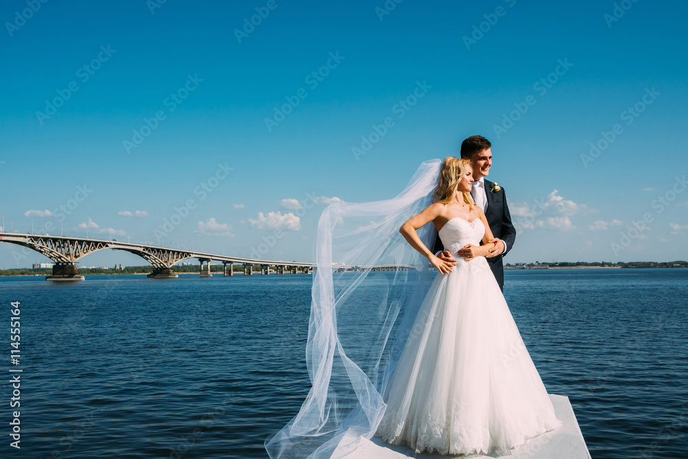 the bride and groom take pictures near the river the bride and groom take pictures near the river
