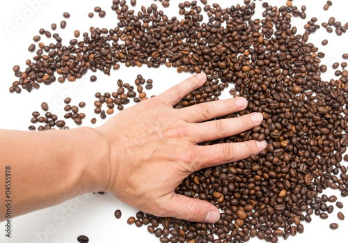 hand on coffee beans as background