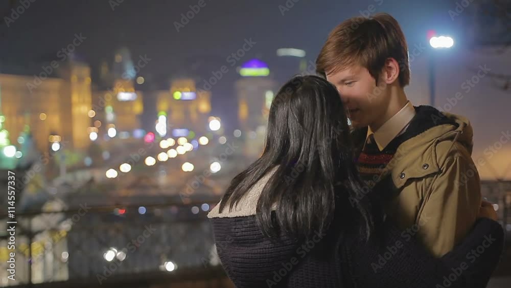 Excited teenage couple in love enjoying romantic date in beautiful night city Excited teenage couple in love enjoying romantic date in beautiful night city