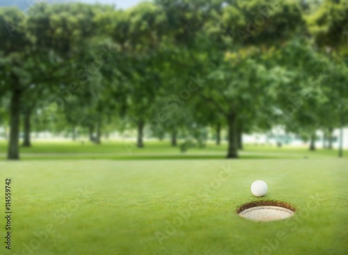 Golf ball at the edge of the hole
