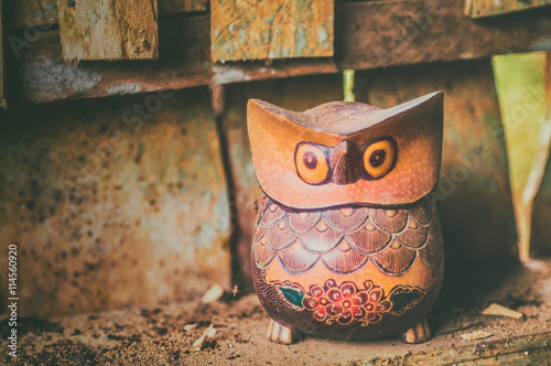 Copyrighted free image of dusty wooden owl sculpture decorate with hand written batik ornament