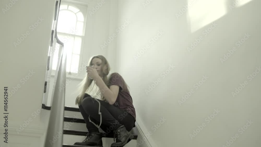 Teenager girl running staircase wearing headphones Teenager girl running staircase wearing headphones