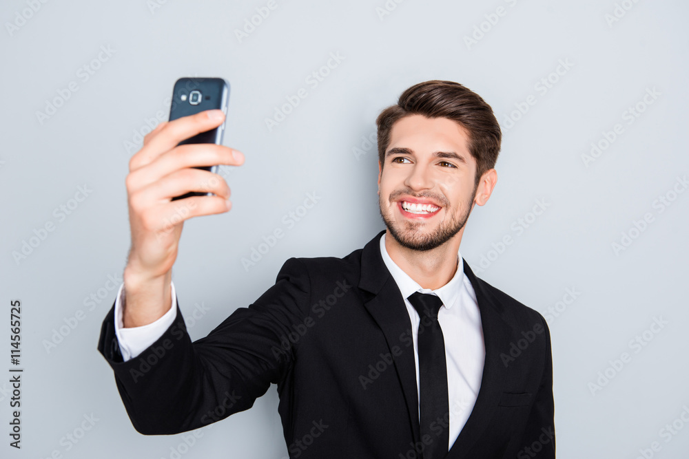 Handsome smiling man in black suit making selfie Handsome smiling man in black suit making selfie