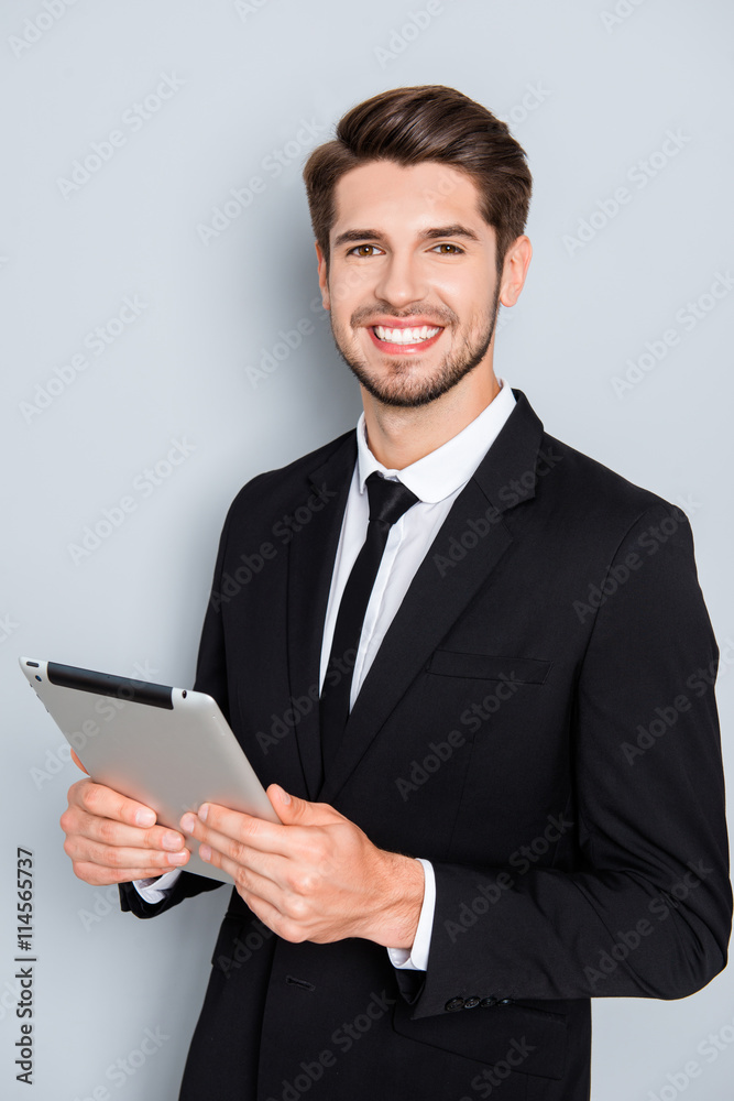 Happy successful young businessman holding digital tablet Happy successful young businessman holding digital tablet