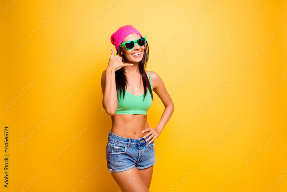 Funny cheerful hipster asking to call her and smiling Funny cheerful hipster asking to call her and smiling