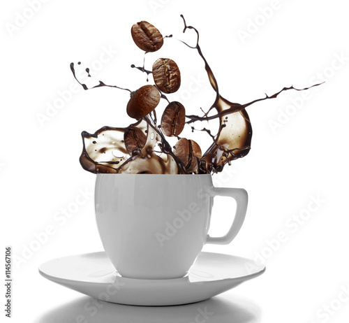 Ceramic cup with splashing coffee isolated on white photo