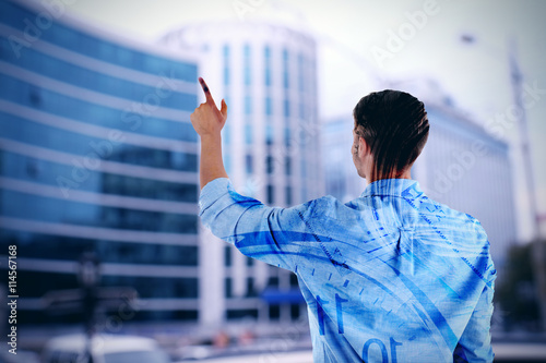 Back view of young man pointing on abstract blur background, double exposition