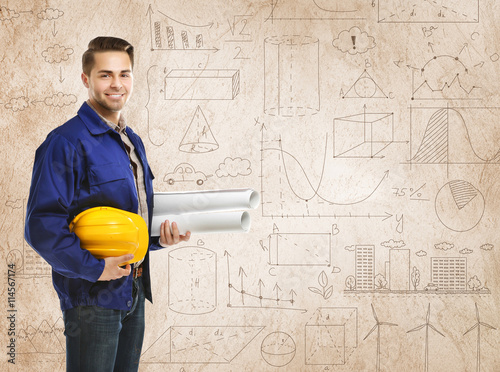 Engineer with blueprints an...