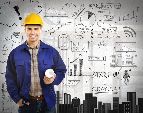 Engineer with blueprints an...