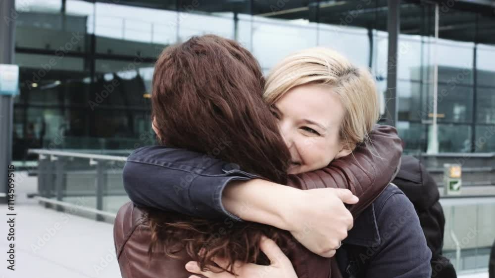 Reunited and hugging friends on airport arrival