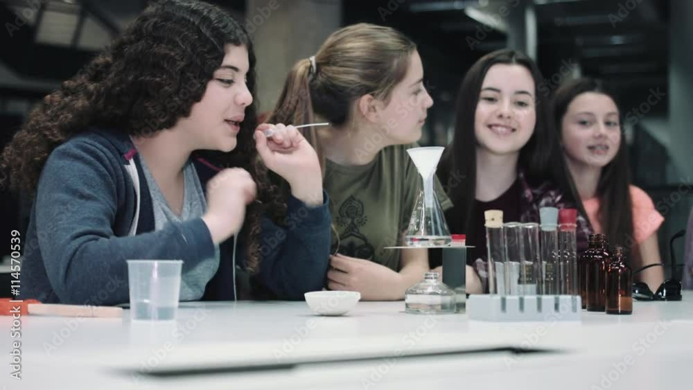Group of girls practice chemistry at school Group of girls practice chemistry at school