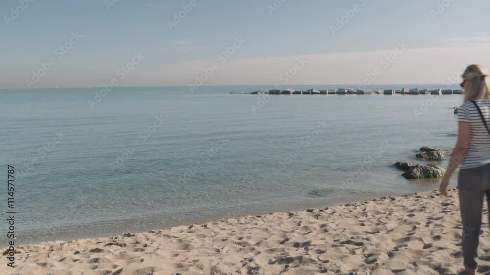 Young adult women walking by the beach in summer Young adult women walking by the beach in summer