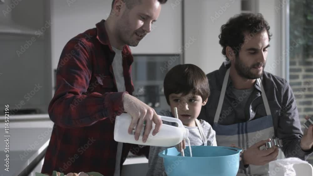 Same sex couple family cooking biscuits