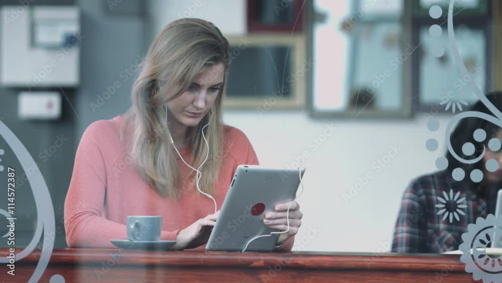 Female in coffee shop working on digital tablet