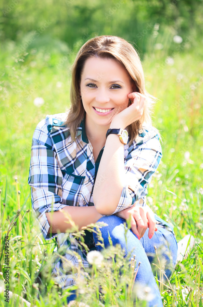 Portrait of a beautiful attractive woman in the grass Portrait of a beautiful attractive woman in the grass