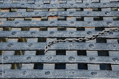 Chain on cast iron lattice, close up 