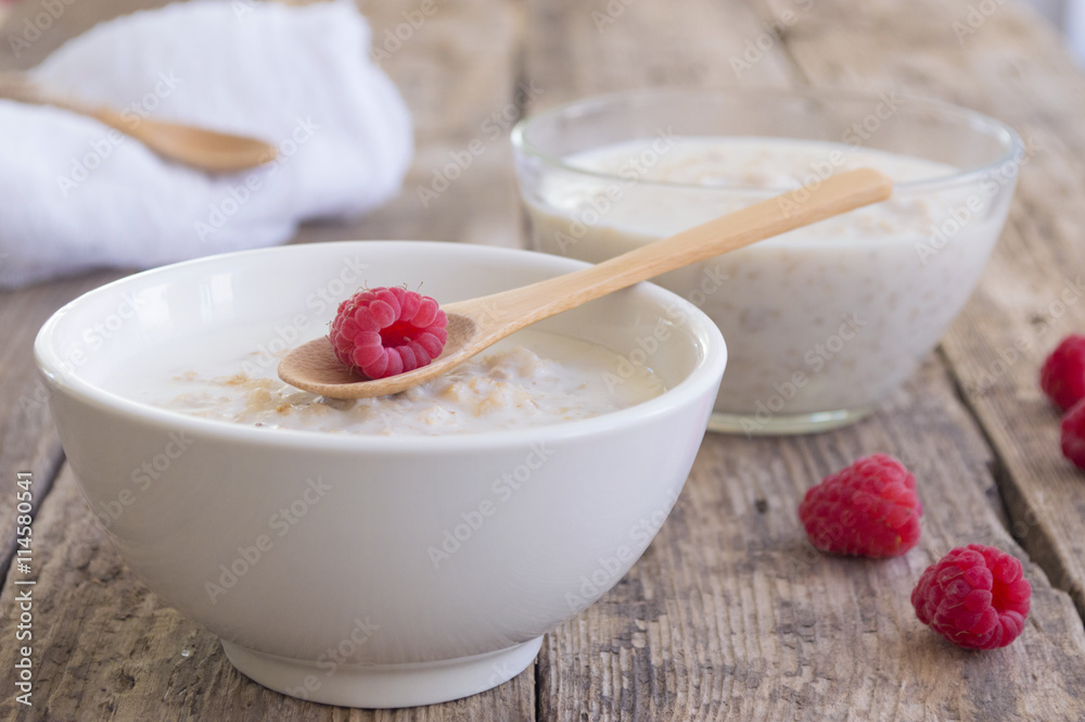A healthy breakfast . Milk porridge with raspberries A healthy breakfast . Milk porridge with raspberries
