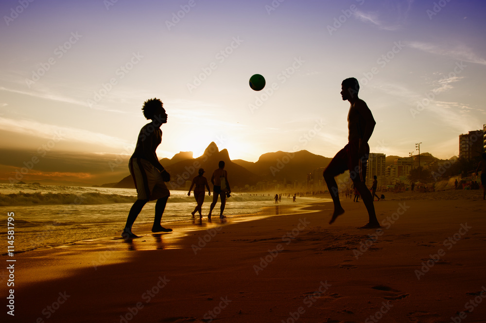 Naklejka premium Two guys with ball at beach at Rio de Janeiro