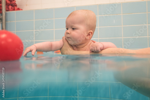 baby girl enjoying her first swim 