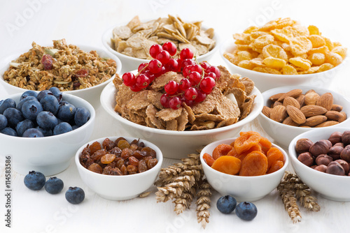 assortment of different breakfast cereal, dried fruit 