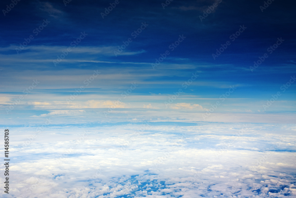 deep blue sky with clouds, a view from airplane window
