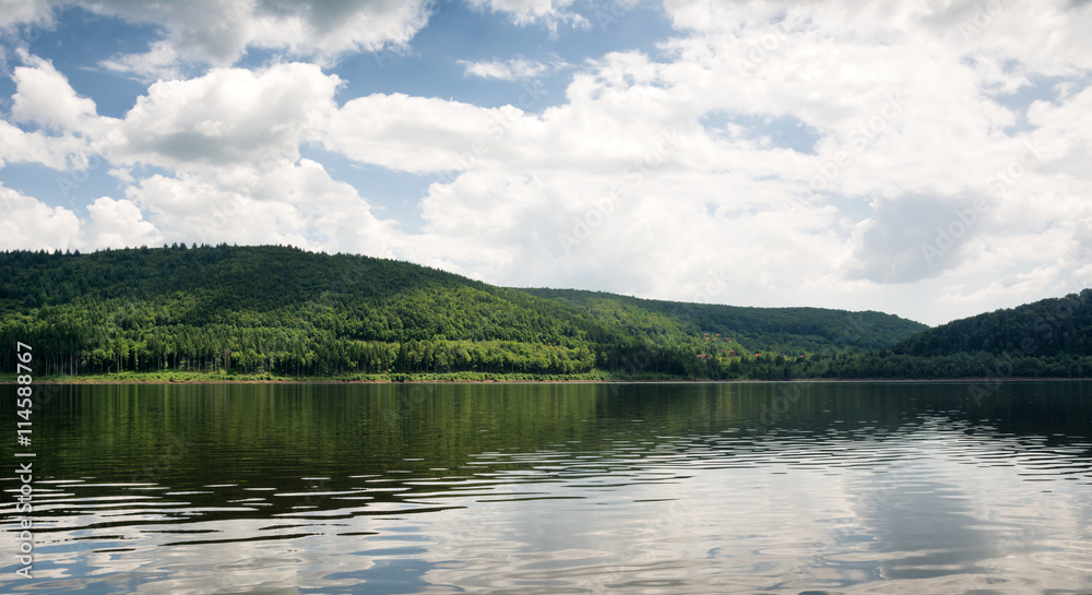 Clouds over lake in the Carpathians mountains